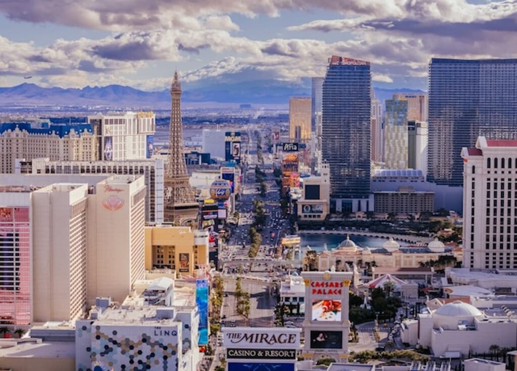 Aerial view of a busy urban skyline with tall buildings under dramatic clouds.