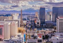 Aerial view of a busy urban skyline with tall buildings under dramatic clouds.