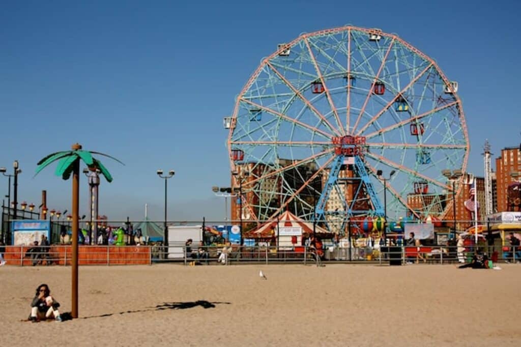 Coney Island’s Wonder Wheel on a sunny day with the beach in the foreground