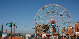 Coney Island’s Wonder Wheel on a sunny day with the beach in the foreground