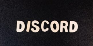 DraftKings & MGM CEOs Split on Prediction Markets The word “DISCORD” spelled out in cutout letters on a black textured background.