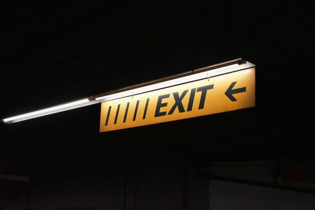 Exit sign illuminated in a dark setting.