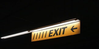 Exit sign illuminated in a dark setting.