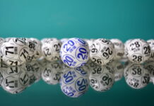Lottery balls with numbers displayed on reflective surface