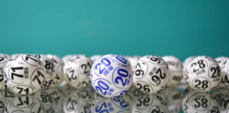 Lottery balls with numbers displayed on reflective surface