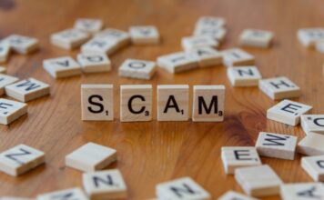 Scam spelled out in Scrabble tiles