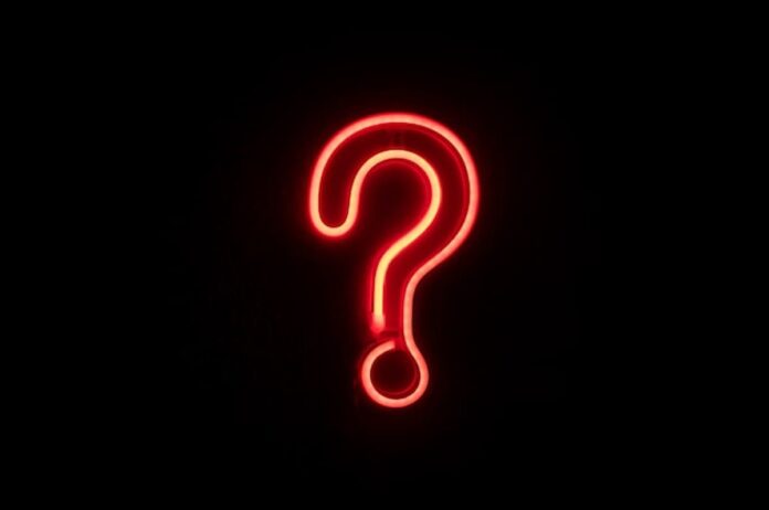 Bright red neon question mark glowing against a dark background