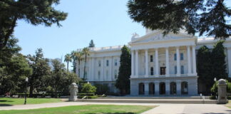 Front view of the California State Capitol building in Sacramento on a sunny day.