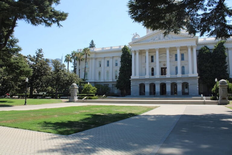 Front view of the California State Capitol building in Sacramento on a sunny day.