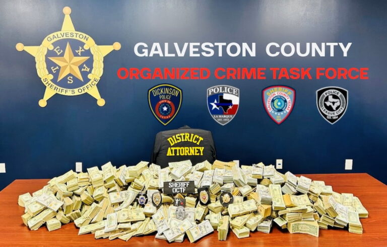 Stacks of seized cash displayed by law enforcement after a criminal investigation