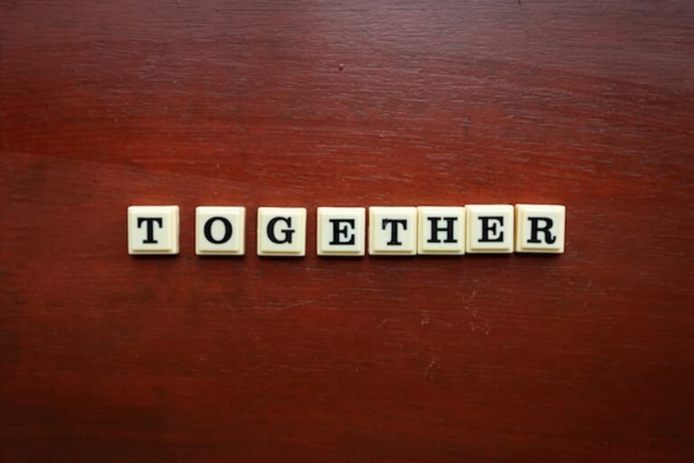 Letter tiles spelling the word “together” on a wooden surface