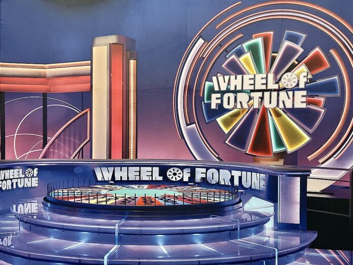 Wheel of Fortune game show set with colorful wheel and stage design