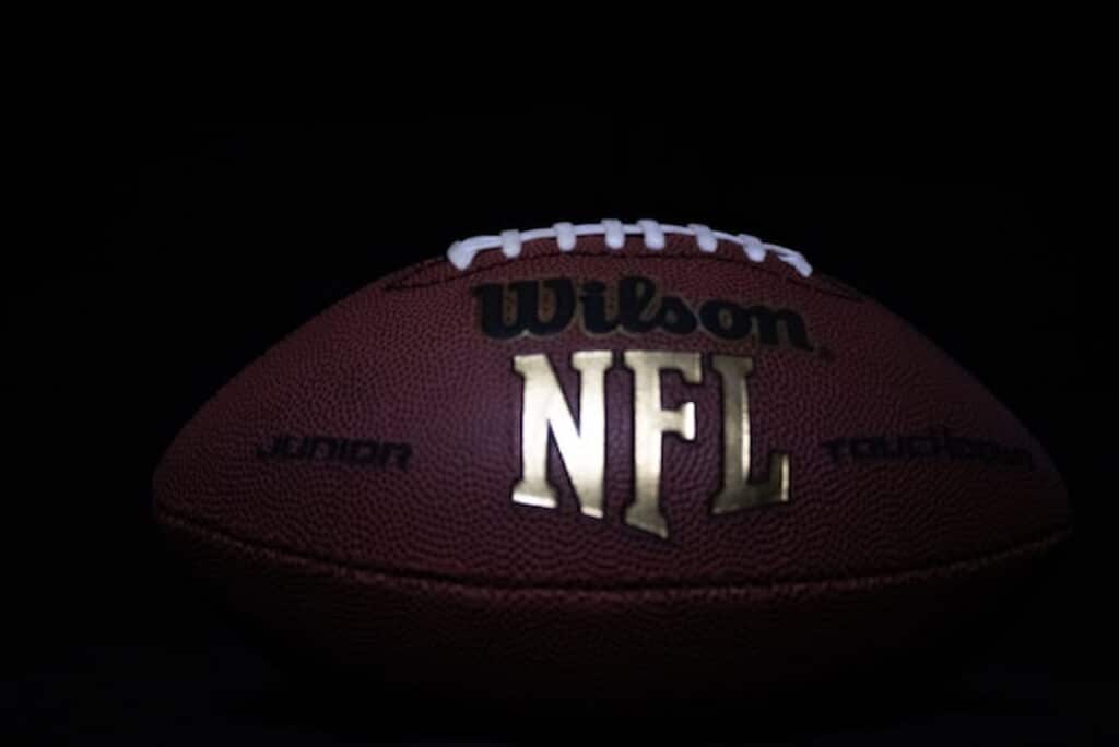 Close-up of a Wilson NFL football on a dark background