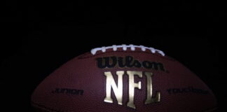 Close-up of a Wilson NFL football on a dark background