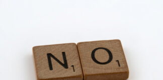 Two wooden letter tiles on a white background