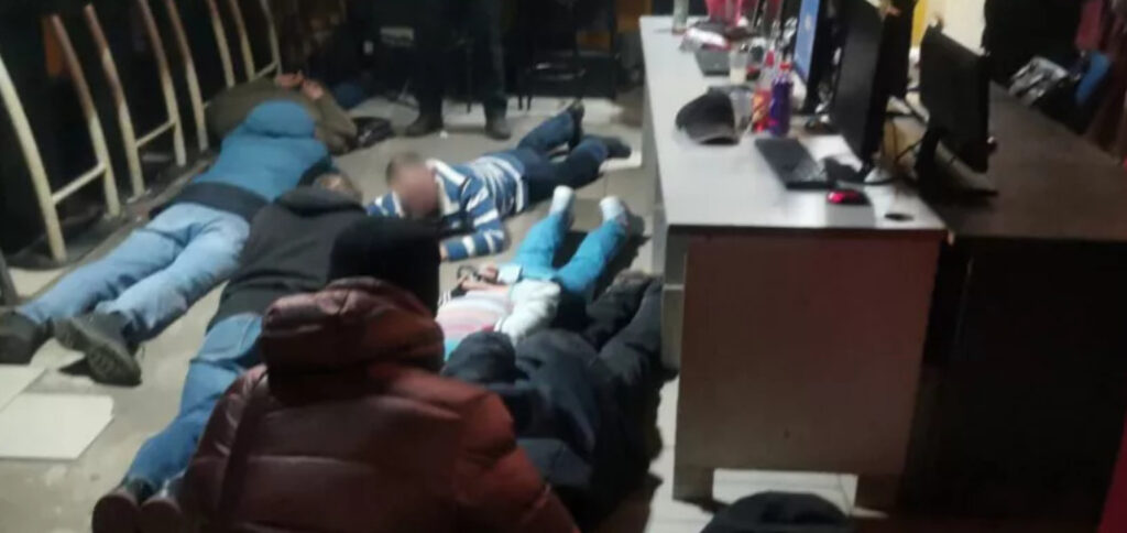 Police order suspects to lie on the ground in a raid on a suspected illegal casino in Russia’s Vologda Region.