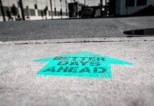 Caesars Says Vegas Slump Over, Keeps Eyes on 20% Digital Growth Arrow painted on pavement reading “Better Days Ahead.”