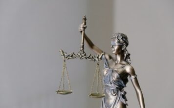 Bronze statue of Lady Justice holding scales of law