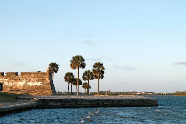 Castillo de San Marcos National Monument with palm trees along the waterfront in St. Augustine, Florida.