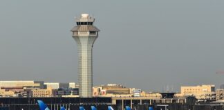 Chicago O’Hare International Airport control tower and United Airlines jets on the tarmac.
