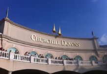 Churchill Downs racetrack building exterior under clear blue sky.