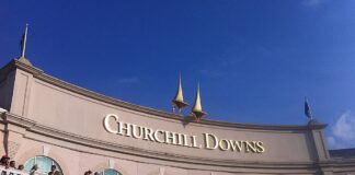 Churchill Downs racetrack building exterior under clear blue sky.