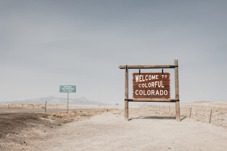 Welcome to Colorful Colorado road sign in desert landscape.