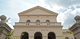 Two More Plead Guilty in Florida Gambling Case Tied to Suspended Sheriff Front view of a classical courthouse building under partly cloudy sky