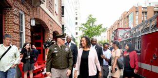 Washington D.C. Mayor Muriel Bowser walking outside with officials during a public appearance.