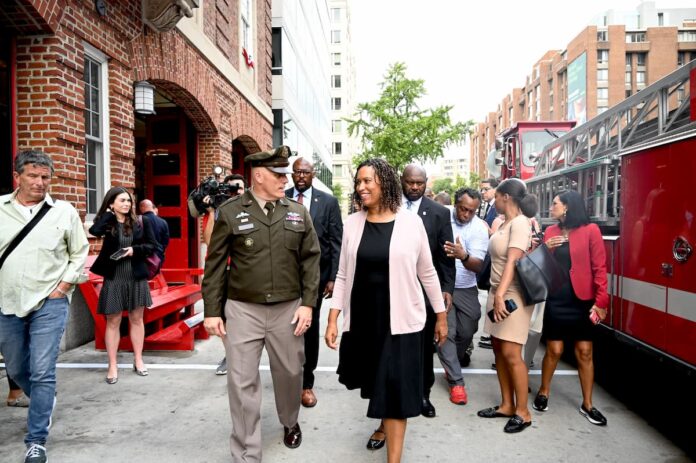 Washington D.C. Mayor Muriel Bowser walking outside with officials during a public appearance.