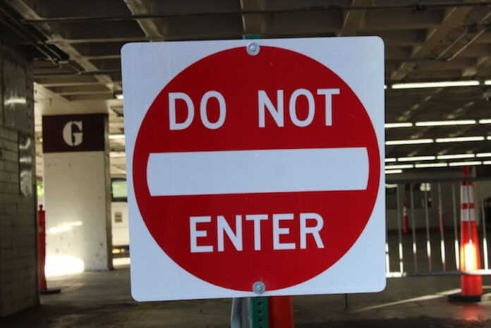 AGA Urges NBA, NFL & MLB Not To Follow NHL With Prediction Market Deals Red and white “Do Not Enter” traffic sign in a parking structure