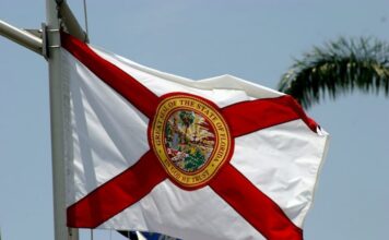 Florida House Approves Bill to Stem Rapid Spread of Illegal Gambling Florida state flag waving against a clear sky