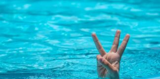 Underdog Named 3rd Best Startup in US as it Expands into Prediction Markets Hand showing three fingers above a swimming pool surface