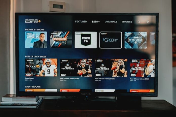 Television screen displaying ESPN Plus interface in a living room.