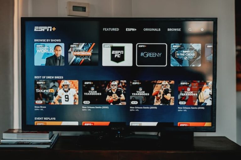 Television screen displaying ESPN Plus interface in a living room.