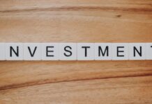 NYSE Owner ICE Takes $2B Stake in Polymarket as It Prepares US Return Scrabble letter tiles spelling the word investment on a wooden surface.