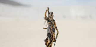 Class Action Lawsuit Filed Against Kalshi Over Unlawful Sports Gambling Bronze statue of Lady Justice holding scales and sword outdoors