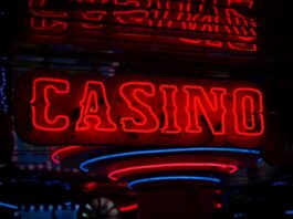 Golden Pony Casino in State of Limbo Amid Tribal Warfare Red neon casino sign glowing against dark background.
