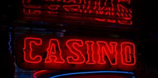 Indiana Lawmakers Pushing for Fort Wayne Resort Casino Next Year Red neon casino sign glowing against dark background.