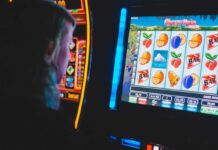 Henry County Gas Station Attack Rekindles Virginia Skill Game Debate Person playing a colorful slot-style machine.