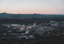 Roanoke Becomes Latest City to Consider Casino Expansion in Virginia Aerial view of downtown Roanoke, Virginia, surrounded by the Blue Ridge Mountains at dusk.