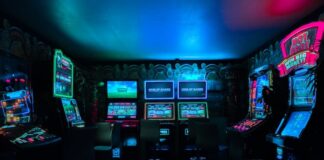 Florida & Texas Lawmakers Weigh Bans on Unregulated Gambling Machines Row of brightly lit gambling-style arcade machines in a dark room.