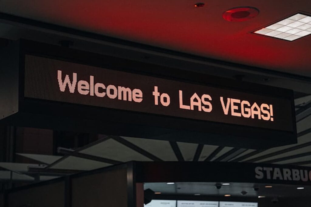 Digital airport sign reading “Welcome to Las Vegas”