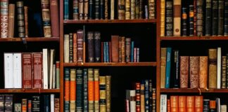Leather-bound books on shelves.