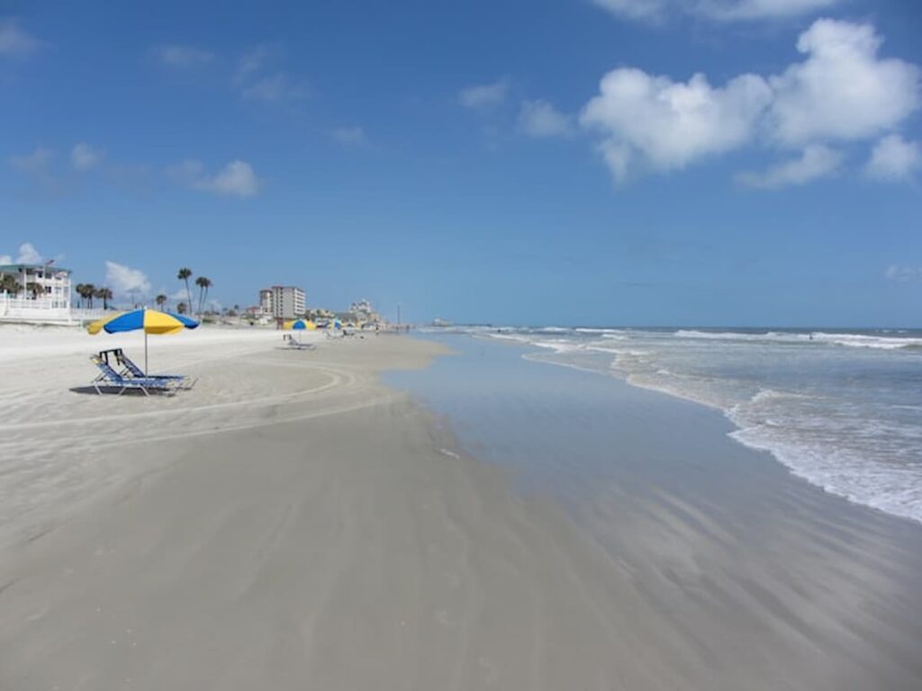 Sandy beach with umbrellas under a clear blue sky