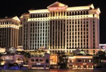 Caesars Faces $7.8M Nevada Penalty Over Allowing Illegal Bookmaker Mathew Bowyer to Gamble for Years Exterior view of Caesars Palace in Las Vegas illuminated at night