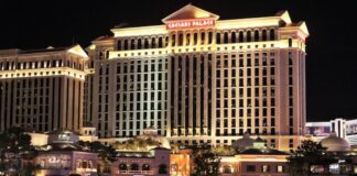 Caesars Faces $7.8M Nevada Penalty Over Allowing Illegal Bookmaker Mathew Bowyer to Gamble for Years Exterior view of Caesars Palace in Las Vegas illuminated at night