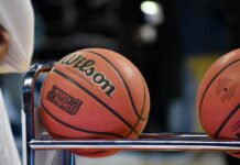 Close-up of a basketball resting on a metal rack