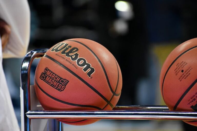 Close-up of a basketball resting on a metal rack