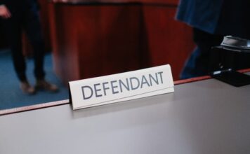 Defendant nameplate on courtroom table.